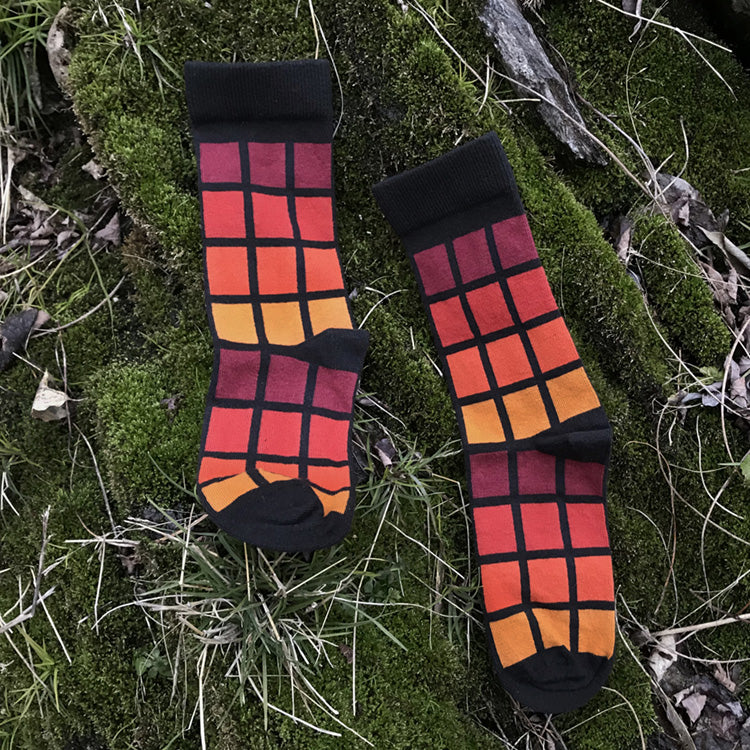 MADE IN USA women's black geometric cotton socks inspired by R62A NYC Subway car with maroon, paprika, orange, + yellow-orange pattern