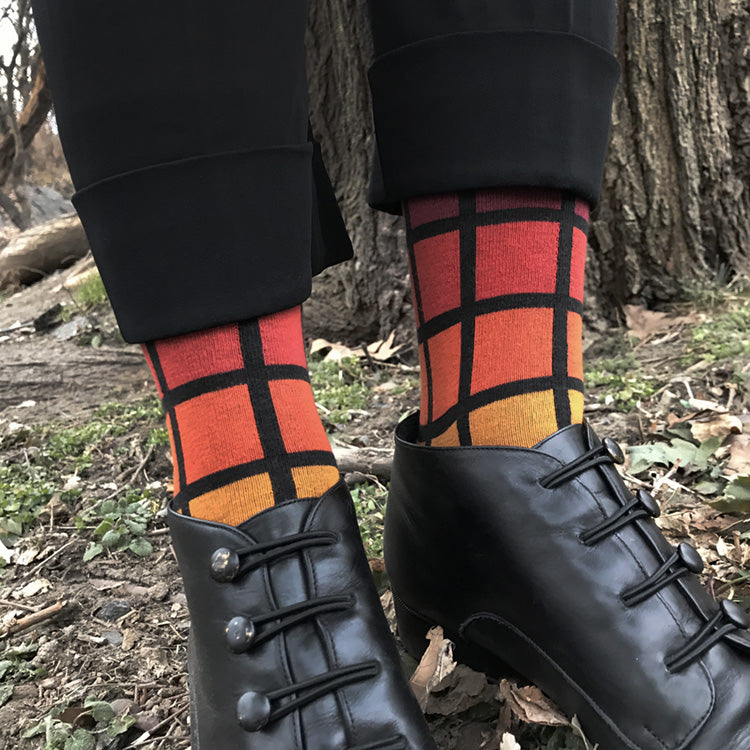 MADE IN USA women's black geometric cotton socks inspired by R62A NYC Subway car with maroon, paprika, orange, + yellow-orange pattern