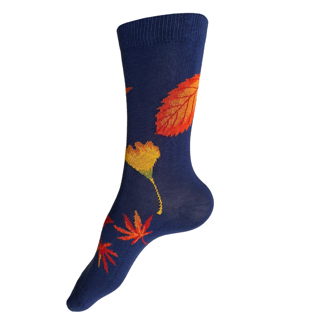 Made in USA women's cotton fall foliage socks with orange and yellow maple and gingko leaves on a bright blue background by THIS NIGHT