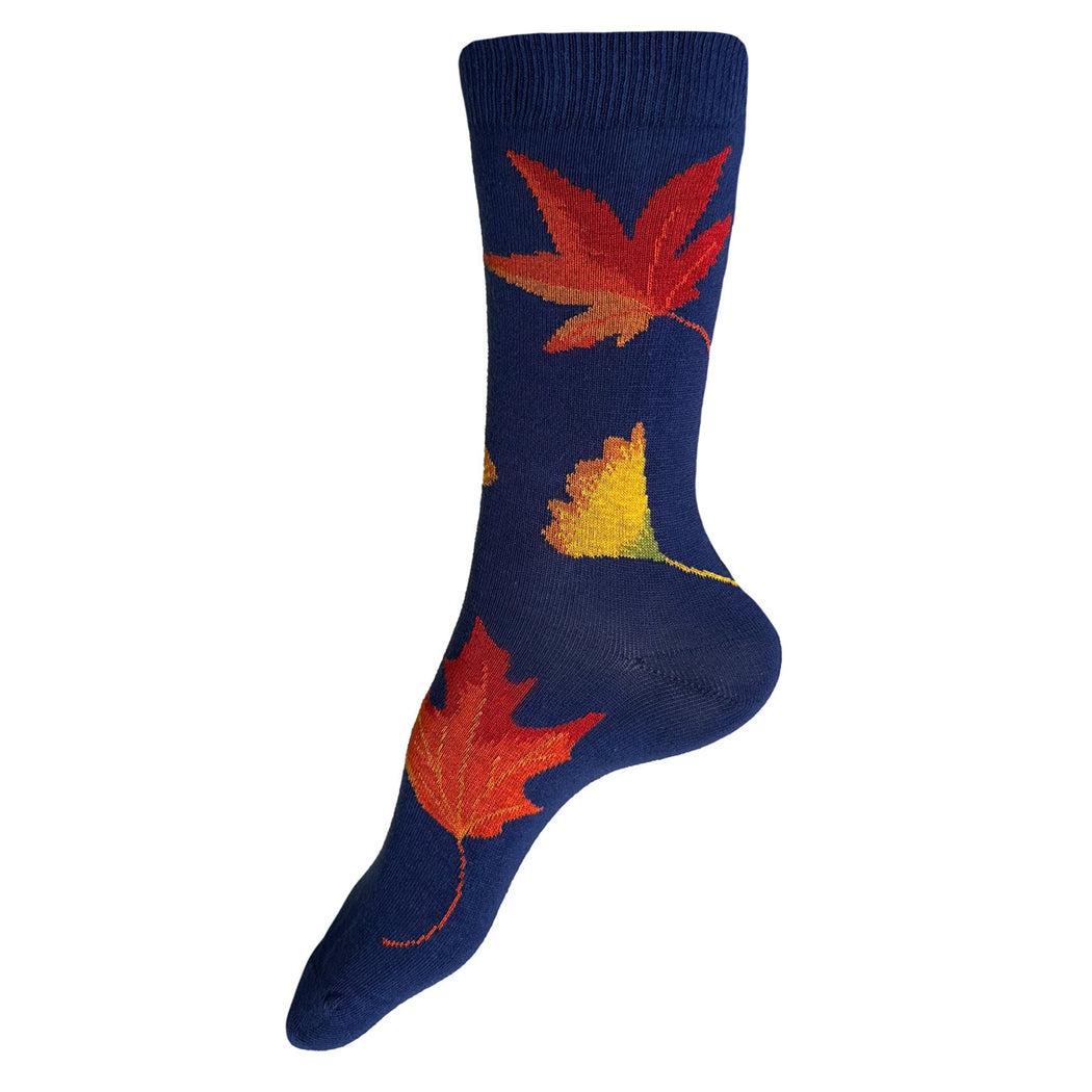 Made in USA women's cotton fall foliage socks with orange and yellow maple and gingko leaves on a bright blue background by THIS NIGHT