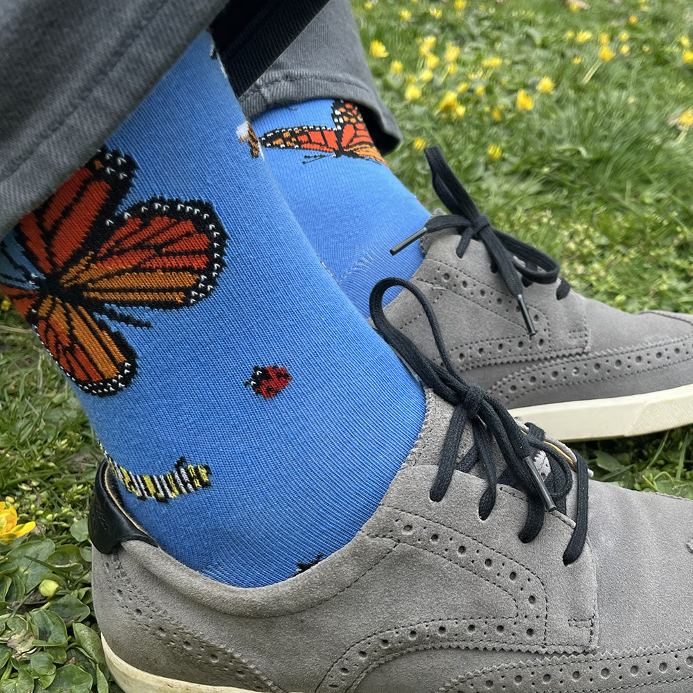 Made in USA men's blue cotton socks featuring bugs: monarch butterflies, honeybees, a caterpillar, ladybugs, and a draogonfly (by THIS NIGHT)