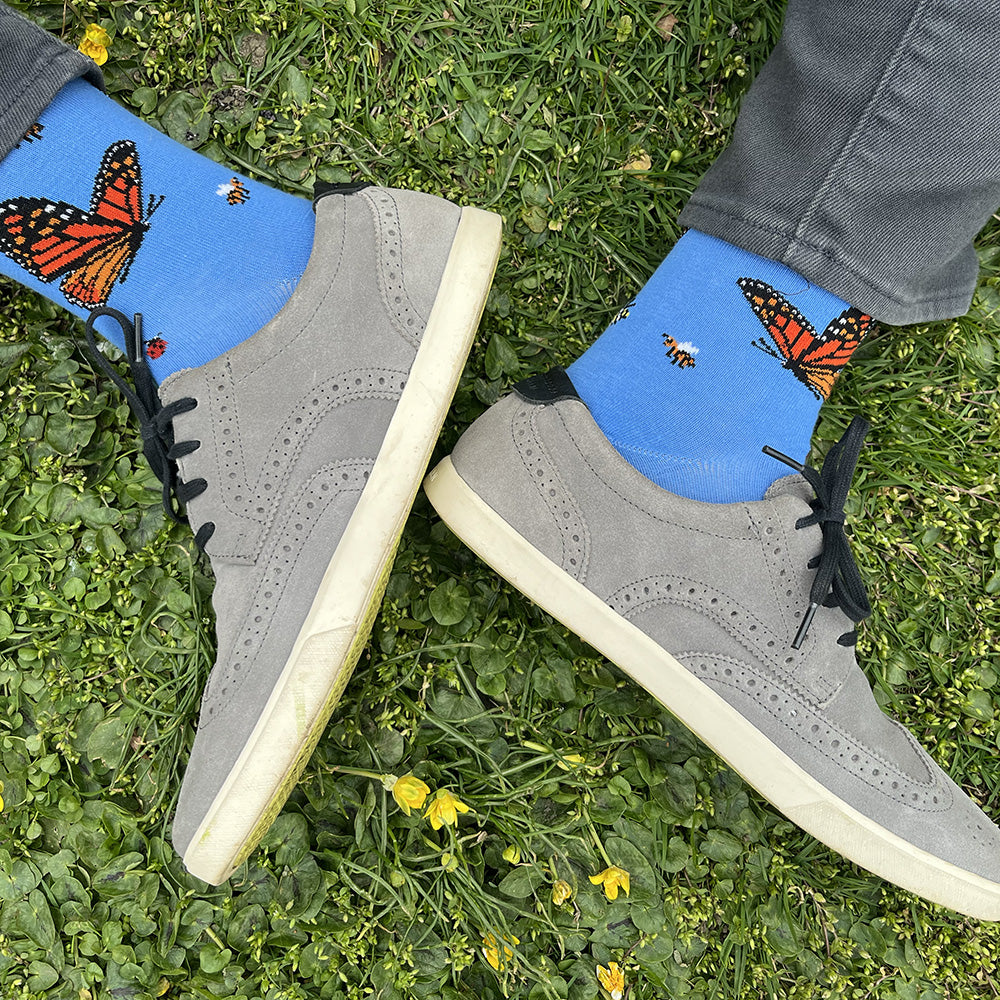 Made in USA men's blue cotton socks featuring bugs: monarch butterflies, honeybees, a caterpillar, ladybugs, and a draogonfly (by THIS NIGHT)