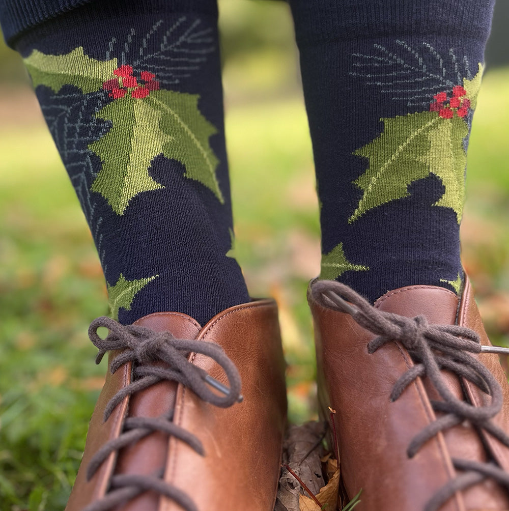 Made in USA women's cotton Christmas socks featuring holly berries and pine needles on navy –– a perfect holiday stocking stuffer!