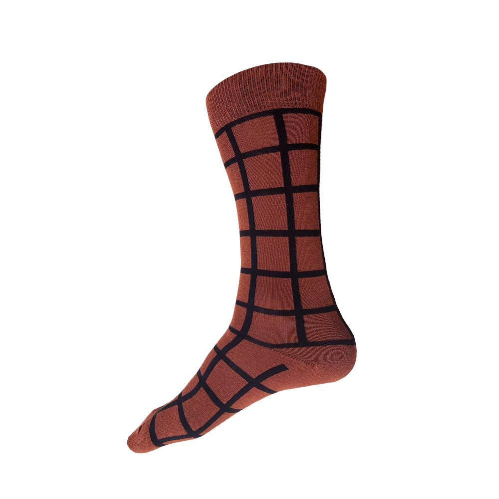 Made in USA men's geometric cotton socks in rust (brown-orange) with a black windowpane plaid grid pattern by THIS NIGHT