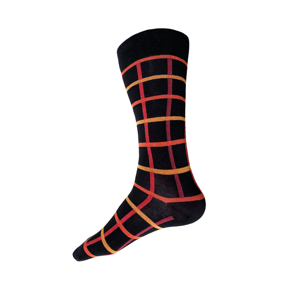 Made in USA men's black cotton geometric socks with oranges, yellows, and reds in a windowpane plaid/grid pattern by THIS NIGHT